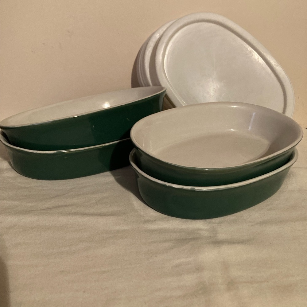 Set of four dark green pottery dishes with lids